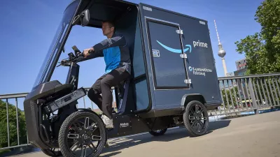 An Amazon delivery driver is using a CargoPack to deliver packages.